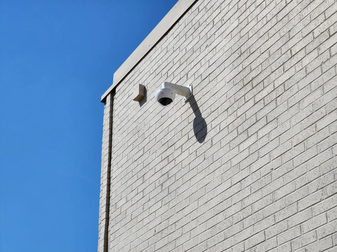 Surveillance camera mounted on warehouse.